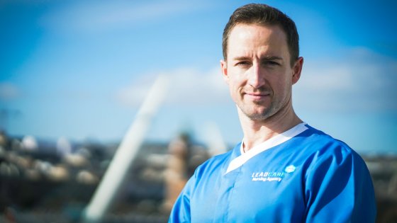 Male Leadcare Recruitment wearing blue scrubs uniform standing in Derry/Londonderry Northern Ireland, on a bright sunny day with clear skys in Northern Ireland. Hire Agency Nurses and HCA