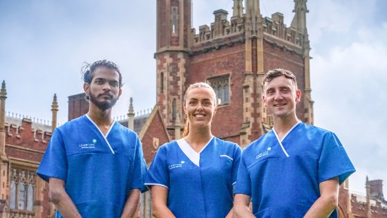 Healthcare Staffing Northern Ireland. Three Leadcare Agency nurses, two men and one woman, stand side by side smiling in front of Queen University Belfast, in Northern Ireland.