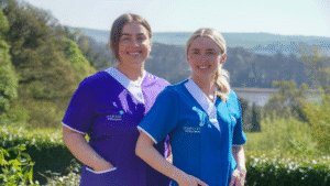 Leadcare Recruitment healthcare assistant (purple uniform) and nurse (blue uniform) smiling.