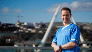 Leadcare nurse in blue uniform standing and smiling in Derry/Londonderry, Northern Ireland.